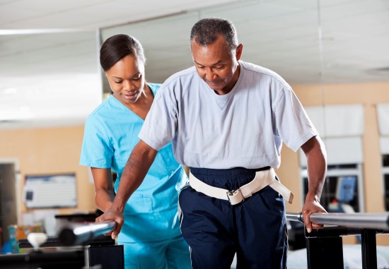 nurse assisting patient with walking