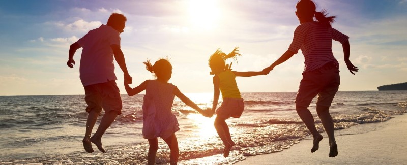 family at beach summer sun safety month (1).jpg